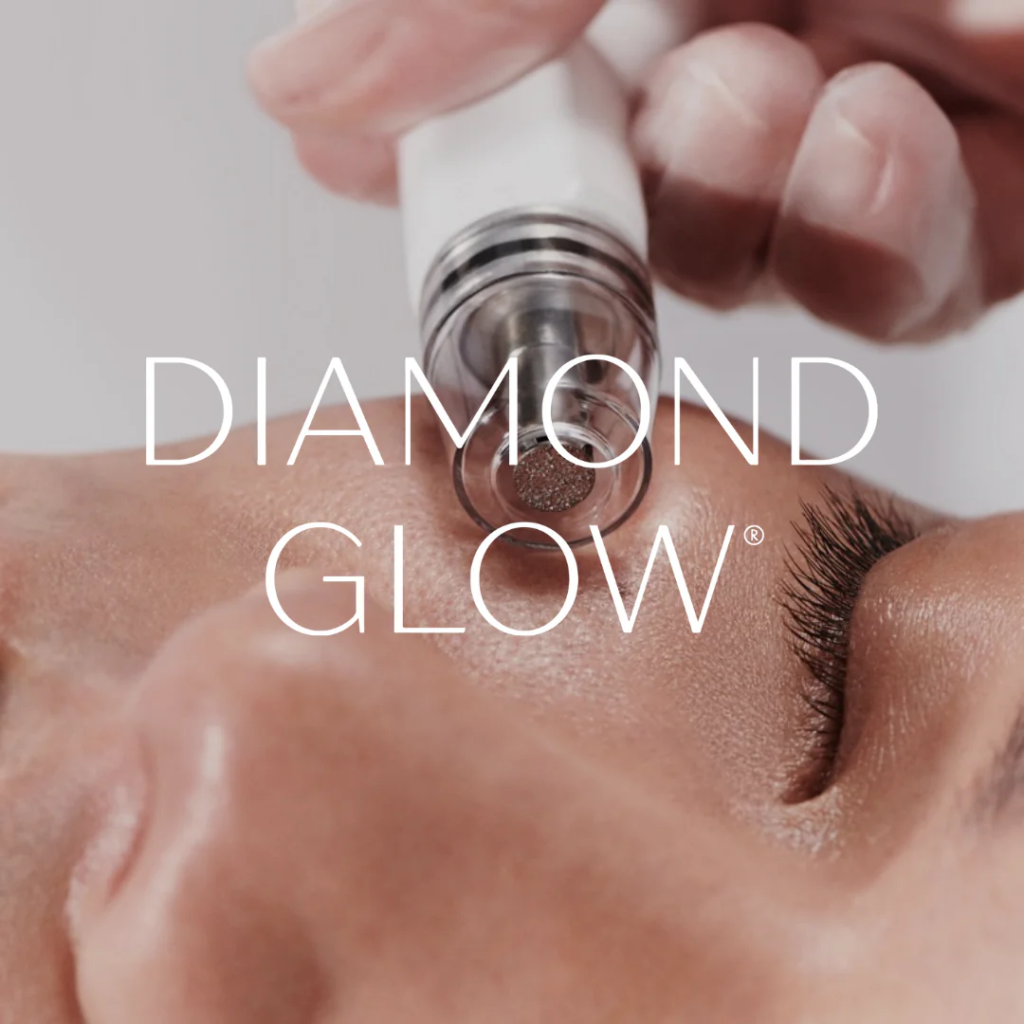 A woman receiving a Diamond Glow Facial at a skincare clinic. The treatment involves a diamond-tipped wand gently exfoliating her skin, followed by extraction and infusion of nourishing serums, resulting in a radiant and youthful complexion.